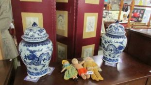 A pair of large blue and white Chinese lidded pots.