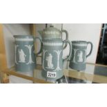 A set of 3 graduated Jasper style jugs together with a coffee pot with Jasper style applied cherubs,