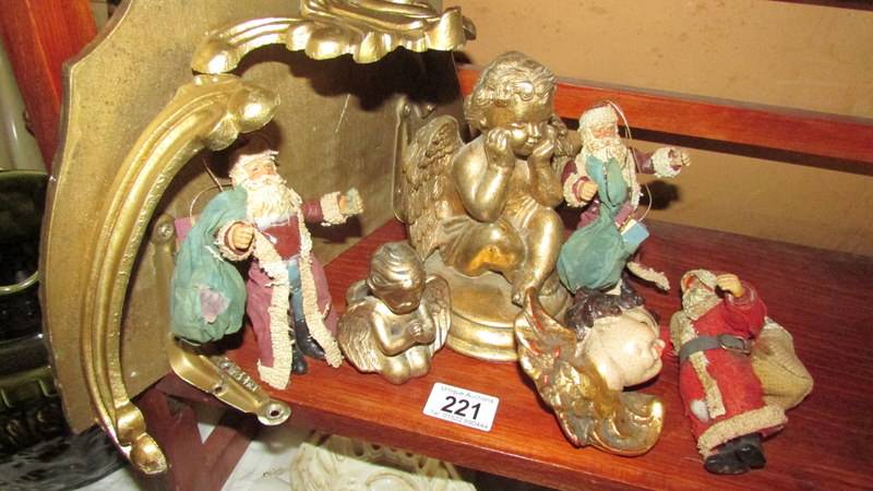 A gilded shelf bracket, 3 cherubs and 3 vintage Santa figures.