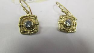 A pair of pretty gold on silver earrings.