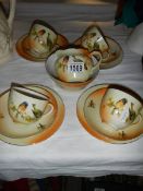 14 pieces of Victorian tea ware decorated with birds.