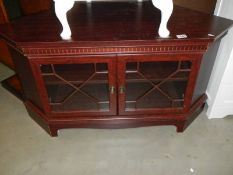 A darkwood stained glazed corner unit