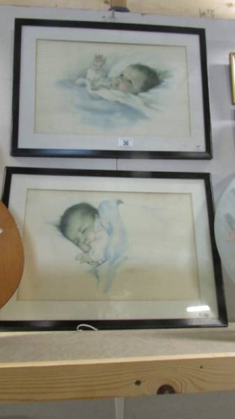 A pair of framed and glazed baby prints.