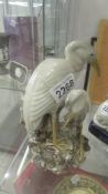A spill vase in the form of a pair of storks.