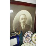 An oval framed and glazed photograph of a gentleman.