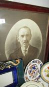 An oval framed and glazed photograph of a gentleman.