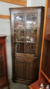 A good oak corner cabinet with linen fold bottom door.