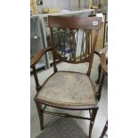 A mahogany inlaid elbow chair.