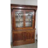 A mahogany display cabinet with lead glazed doors.