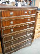 A darkwood stained chest of drawers