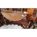 A lovely walnut table with drop sides, pie crust edge and on pad feet.