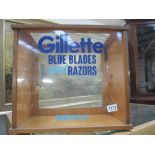 A shop display cabinet with Gilette blue blades & razors decoration