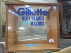 A shop display cabinet with Gilette blue blades & razors decoration