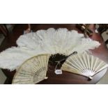 An ostrich feather fan and 2 others.
