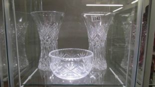 A pair of cut glass vases and a cut glass bowl.