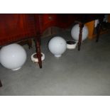 2 large and one smaller white glass globes with some metal ceiling roses.