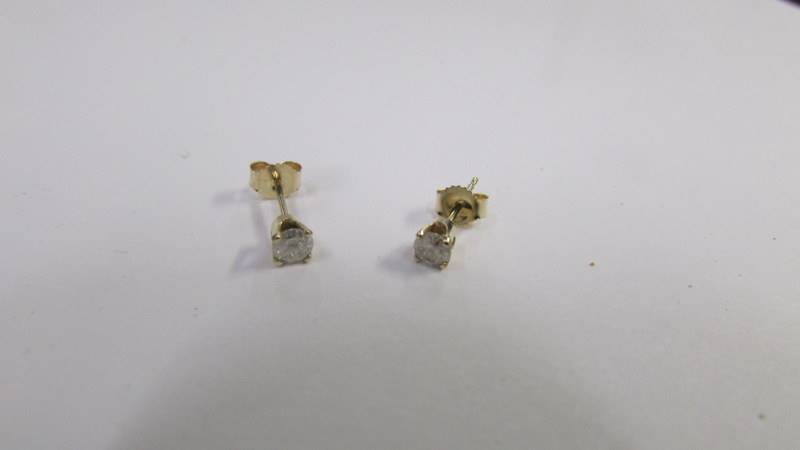 A pair of yellow gold and diamond studs.