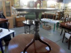 A Victorian mahogany tripod tip top table.