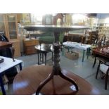 A Victorian mahogany tripod tip top table.