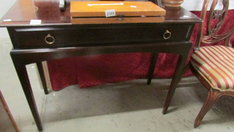 A mahogany single drawer side table.