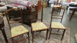 A pair of mahogany inlaid bedroom chairs and one other.
