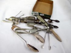 A quantity of silver plated sugar tongs and spoons