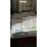 A large quantity of new white Tee shirts in assorted sizes.