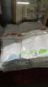 A large quantity of new white Tee shirts in assorted sizes.