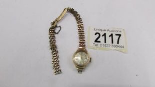 A ladies 9ct gold cased Rotary wrist watch on 9ct gold bracelet, 14 grams, works but bracelet a/f.