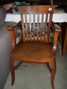 An Edwardian oak carver chair