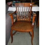 An Edwardian oak carver chair