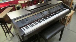A Yamaha Clavinova organ with stool.