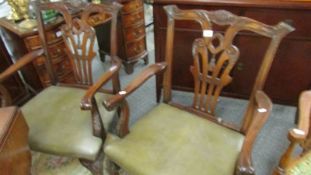 A good pair of carved mahogany elbow chairs.
