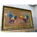 A large gilt framed and glazed wool work of cockerels cock fighting - Collect only