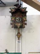 A black forest cuckoo clock with painted decoration,