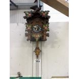 A black forest cuckoo clock with painted decoration,
