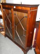 A mahogany astrgal glazed 2 door book case with dovetail cornice