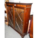 A mahogany astrgal glazed 2 door book case with dovetail cornice