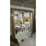 A gilt framed bevel edged mirror.