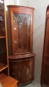 A mahogany astragal glazed corner cabinet.