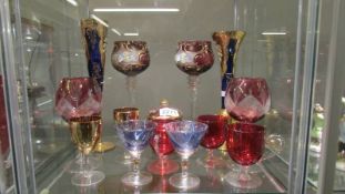 A good mixed lot of coloured and gilded wine glasses.