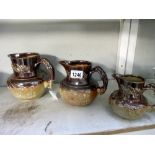 A set of 3 saltglaze graduated jugs