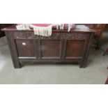 A large carved oak coffer. ****Condition report**** 129cm x 51cm x 66cm.