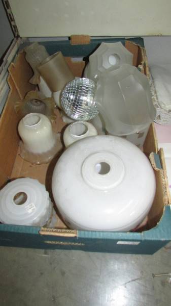 A box of glass lamp shades.