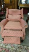 A fully reclining wing arm chair, in good condition but would benefit from a clean.