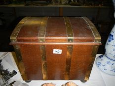 A brass bound oak ply treasure chest style coal box with liner