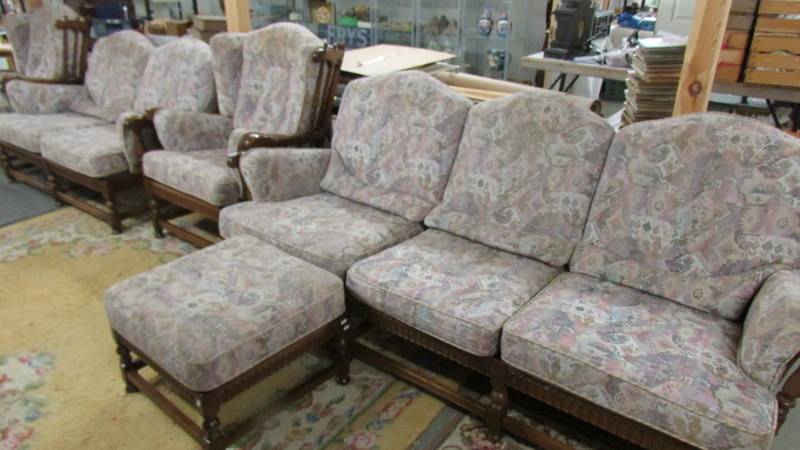 An Ercol five piece suite comprising 3 seat sofa, 2 seat sofa, 2 chairs and a stool.