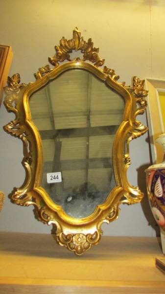 A gilt framed mirror.