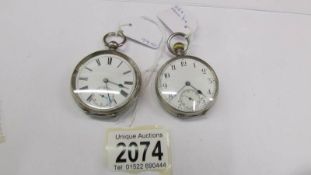 2 open faced silver pocket watches.