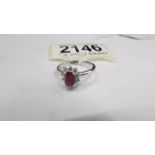 An 18ct gold 20 pt diamond / 75 pt ruby ring, size M, total 3.3 g.